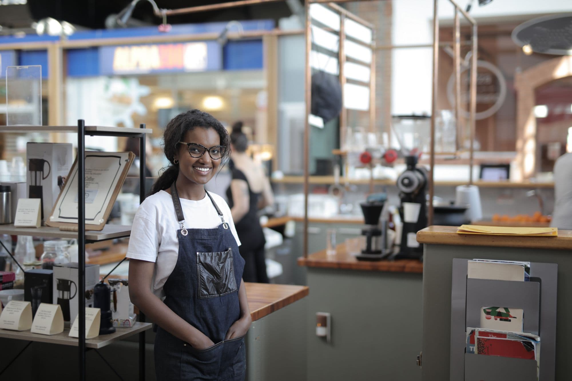 An owner working behind the counter of her cafe
