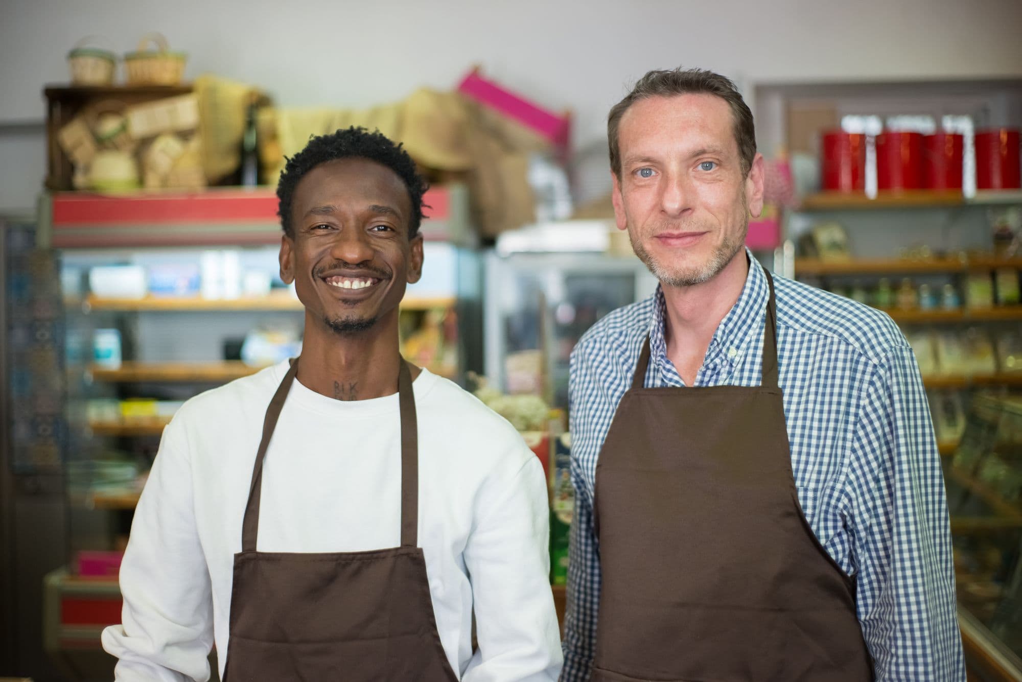 Two owners behind the counter of their shop